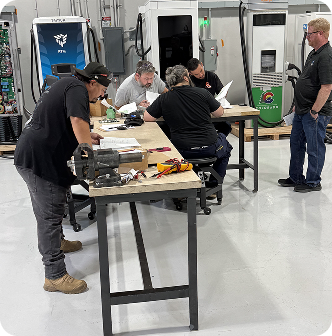 Technicians working on EV components at workbench