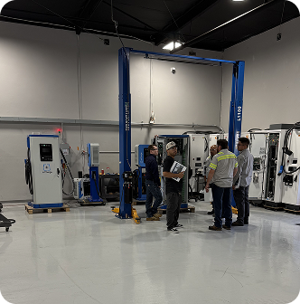 Technicians reviewing blueprints in the main training bay